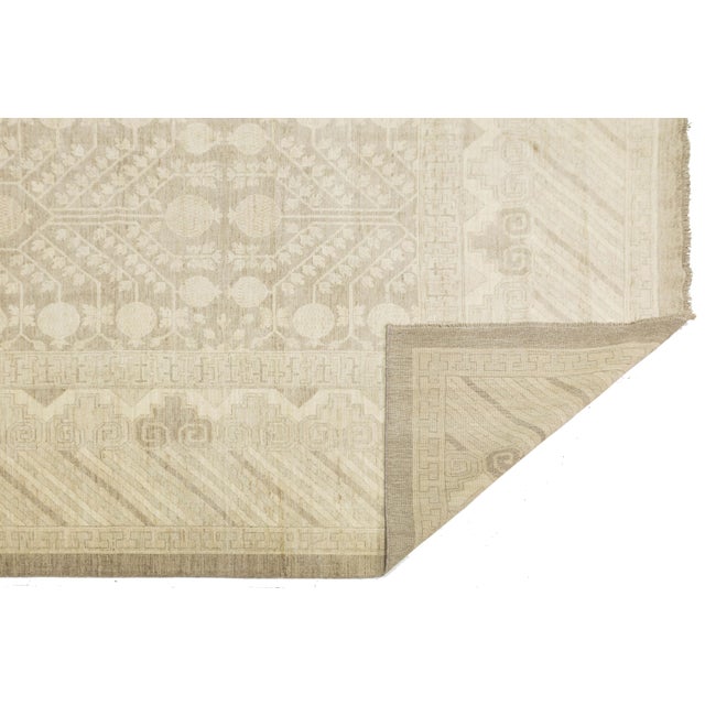 Enhance your space with the elegance of this Modern Khotan Style wool rug. Featuring pomegranate and "Tree of Life" motifs...