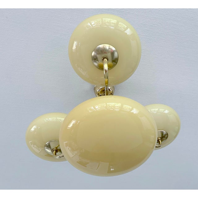Art Deco pendant light from the 1940s featuring a brass structure with wood trim and ivory color opaline glass shades ,...