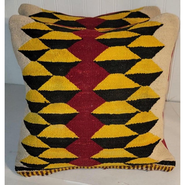 Hand Woven saddle blanket pillows with amazing red leather backing.The inserts are down & feather fill.