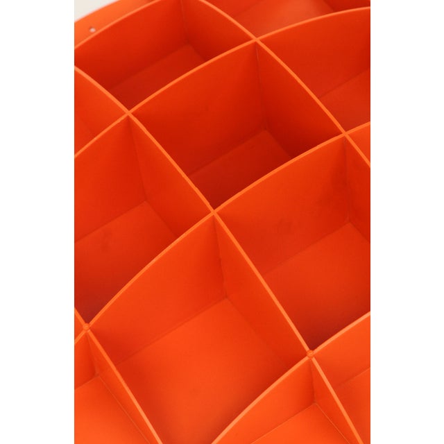 A unique piece that blends functional design and wall sculpture, this Globo shelf in orange thermoformed plastic is a...
