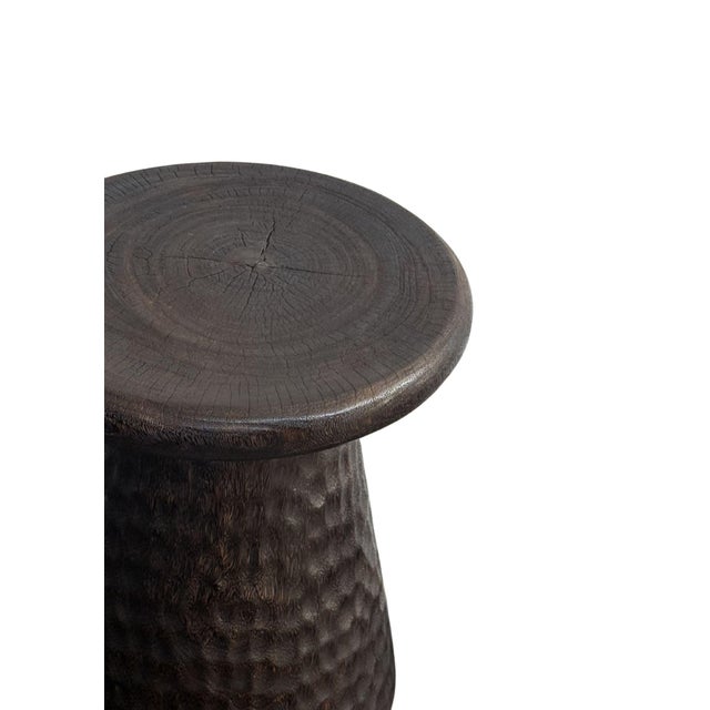 Crafted from solid suar wood by skilled artisans on the island of Bali, this sculptural side table combines organic...