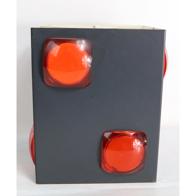 Chic architectural metal shade with translucent orange " jewels". The metal frame is gray on the exterior, white on the...