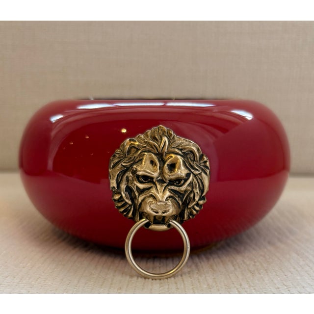 Beautiful vintage Italian ashtray in a stunning glossy candy apple red with metal lions head knockers on the sides. Signed...