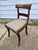 These are 19th-century mahogany dining side chairs in the Federal or Regency style, featuring a curved back rail and sabre...