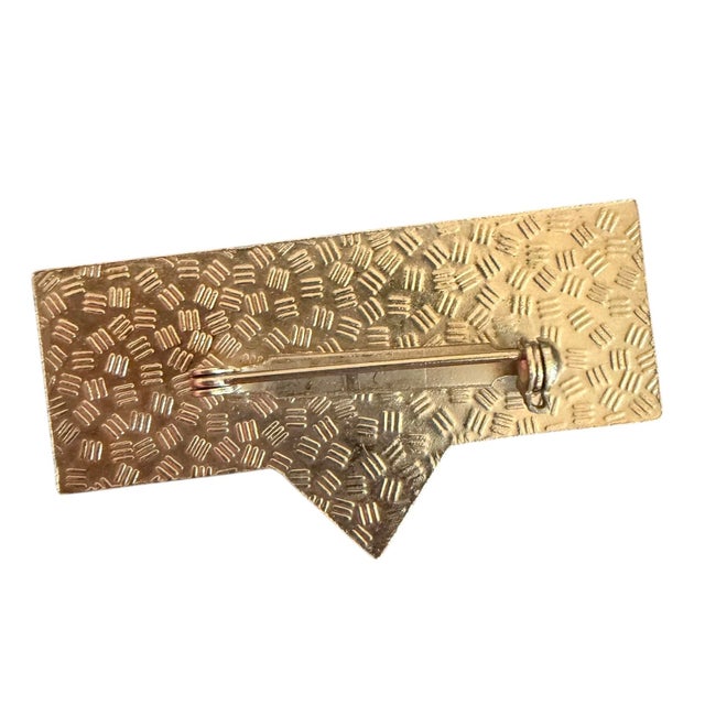 Art Deco brooch made of lucite in black and gold.