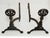 Pair of antique cast iron andirons having dragon medallion finials on turned balusters and splayed feet. Circa 1915.