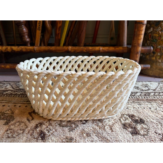 Charming vintage Spanish ceramic basket featuring an intricate open-weave lattice design that beautifully mimics...