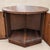 A sculptural round walnut cabinet table from the 1970s, combining a warm wood surface with concealed storage behind curved...