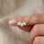 Illuminate your style with this enchanting cluster pendant necklace, featuring three shimmering white gemstones that catch...
