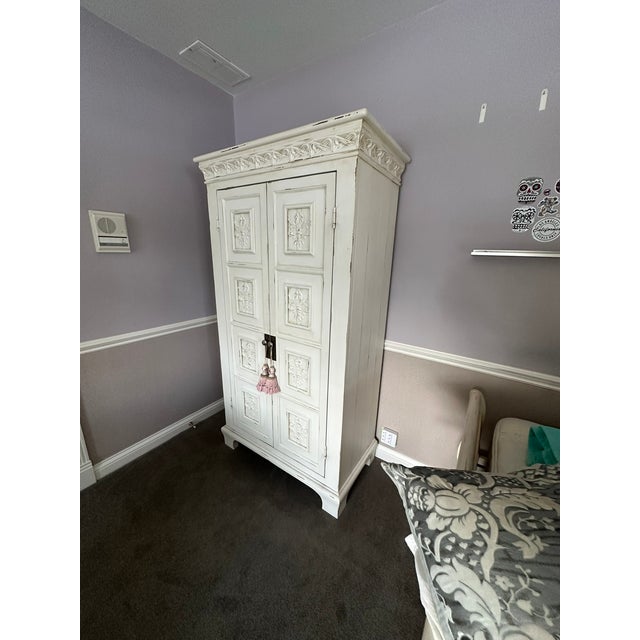 Vintage French-Style White Carved Armoire Add a touch of romantic elegance to your space with this exquisite vintage white...