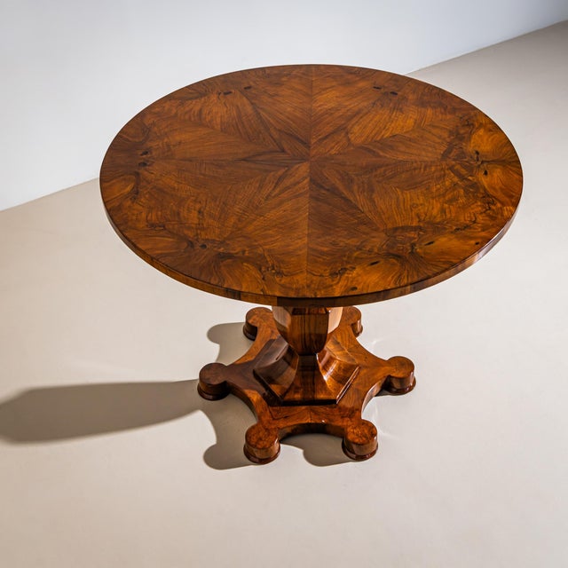 Biedermeier salon table with a tilting top and an exceptional vase-shaped pedestal resting on a multi-lobed base. The...