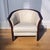 A 1970s barrel-form lounge chair by Ekornes, combining a curved rosewood frame with softly gathered cream leather...