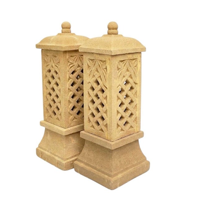 This pair of cast stone lanterns offers a sophisticated architectural element for both interior and exterior spaces....