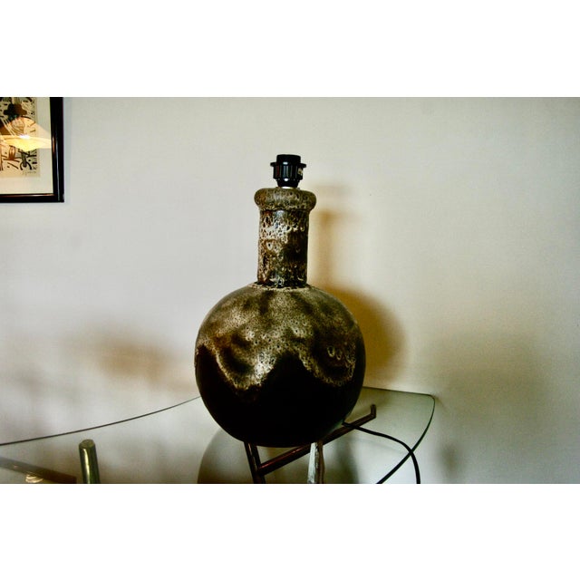 Original wiring in working order, Lava glaze. This piece is attributed to the mentioned designer/maker. It has no...