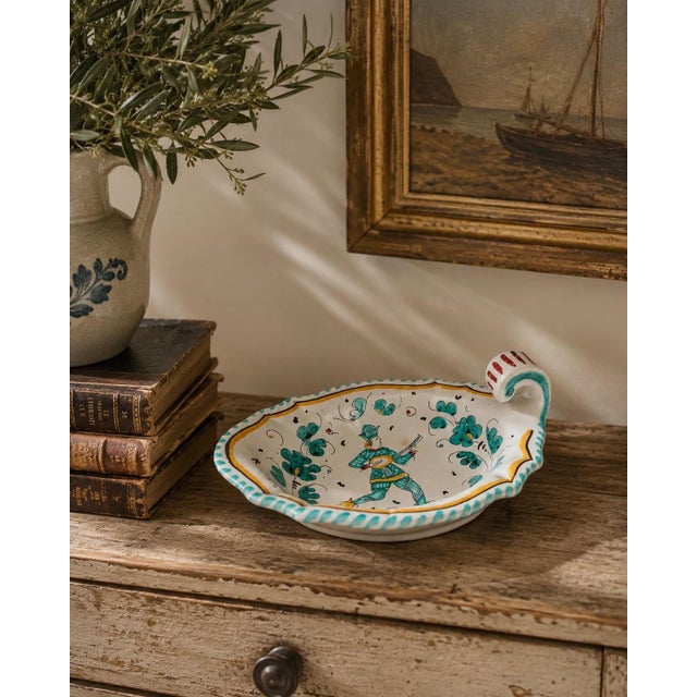 A charming late-20th-century faience bowl by Grazia of Deruta, Italy, hand painted in a lively Renaissance-inspired...