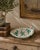 A charming late-20th-century faience bowl by Grazia of Deruta, Italy, hand painted in a lively Renaissance-inspired...