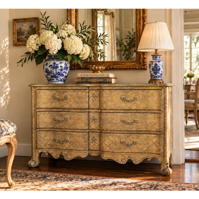 A handsome late-20th-century French Provincial commode by Baker Furniture, distinguished by its softly aged lacquered...