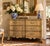 A handsome late-20th-century French Provincial commode by Baker Furniture, distinguished by its softly aged lacquered...