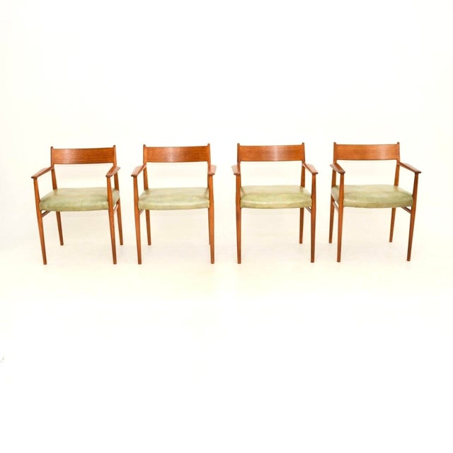 A stylish and extremely well made set of four Danish vintage teak and leather dining chairs by Arne Vodder. They are the...