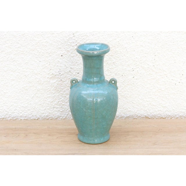 A stunning vessel of quiet power, in a color from the depths of the sea. This porcelain vase is a masterpiece of artistry,...