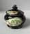 A vintage porcelain lidded sugar bowl by Norleans, made in Japan, featuring a dramatic black ground with hand-painted...