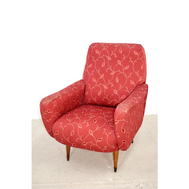 This Italian mid-century armchair is in the style of Marco Zanuso and stands on feet of wood and brass.