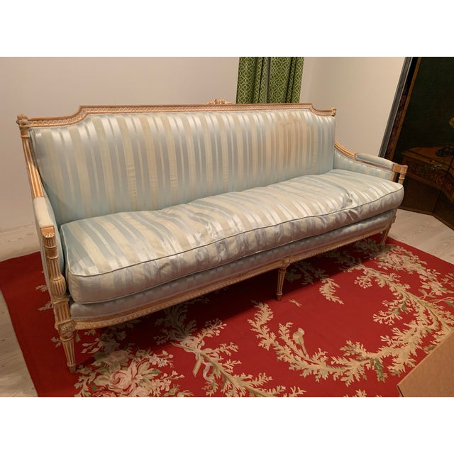 Here we have a gorgeous vintage French Louis XVI style sofa or three person settee. I don't know the exact age, but this...
