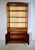 A fine Regency 20th c. banded Mahogany two part bookcase cabinet vitrine. Features to the top include the handsome...