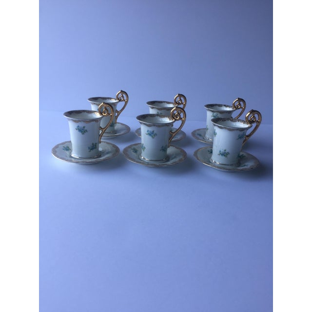 Sip your espresso or Turkish coffee in style by a heavy gold-gilt seahorse-shaped handle. Borders detailed with valance...