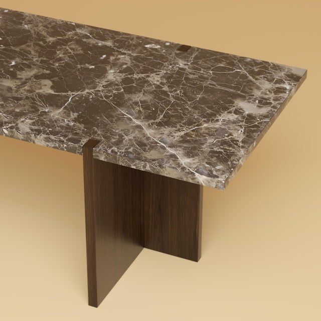 The Palm is an Emperador Dark marble and oak lounge table, a low, elongated table for the space in front of a sofa in...