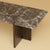 The Palm is an Emperador Dark marble and oak lounge table, a low, elongated table for the space in front of a sofa in...