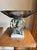 Mid-century Hollywood Regency pedestal centerpiece bowl featuring a thick smoky-gray molded glass dish set on an ornate...