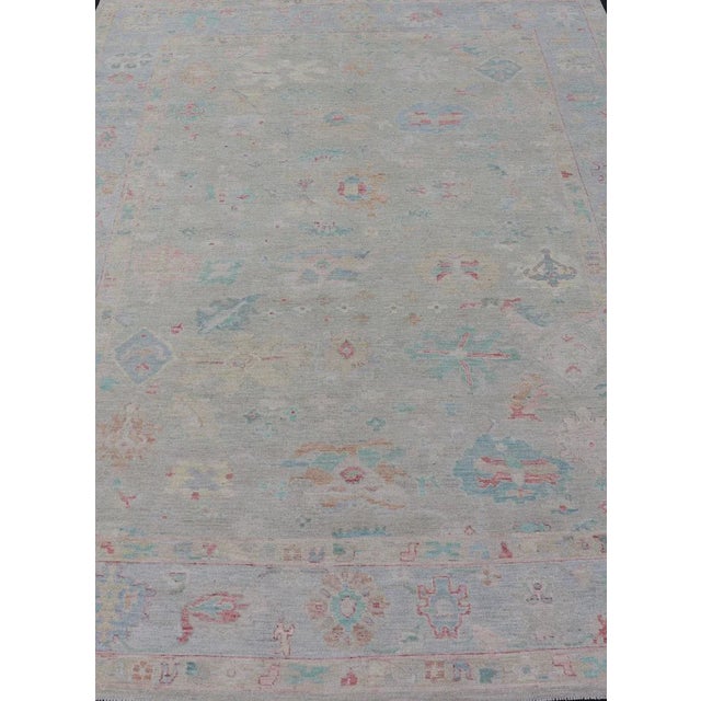 Measures: 9'10 x 13'11 Modern Oushak Floral Motif Design In Light Green Background and Colorful Design. Keivan Woven Arts;...