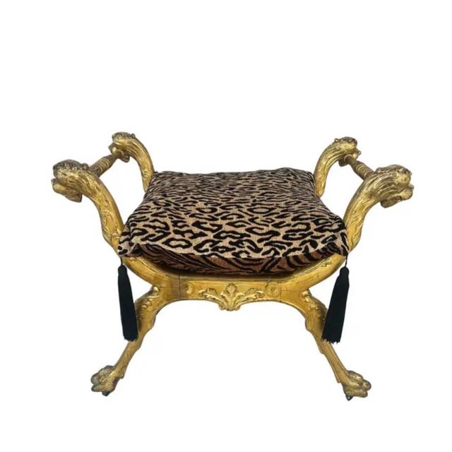 Italian Giltwood Curule Stool with Velvet Leopard Print Cushion. Stool features boldly carved with lion head terminals,...
