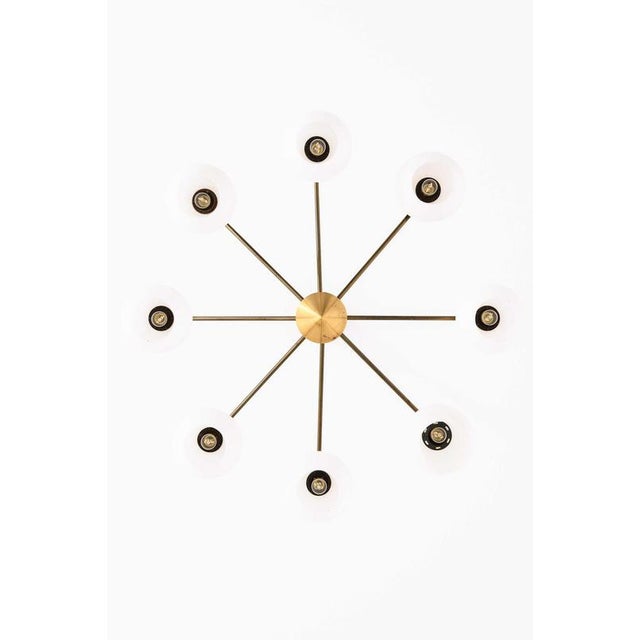 This rare ceiling lamp, produced in Denmark and by an unknown designer, exemplifies the refined material sensibility and...
