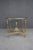 Elegant Italian solid brass center table featuring a round beveled glass top, turned legs, and a sculptural pedestal base...