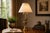 A tall and sculptural brass table lamp base of exceptional decorative presence, featuring a signature palm leaf motif...