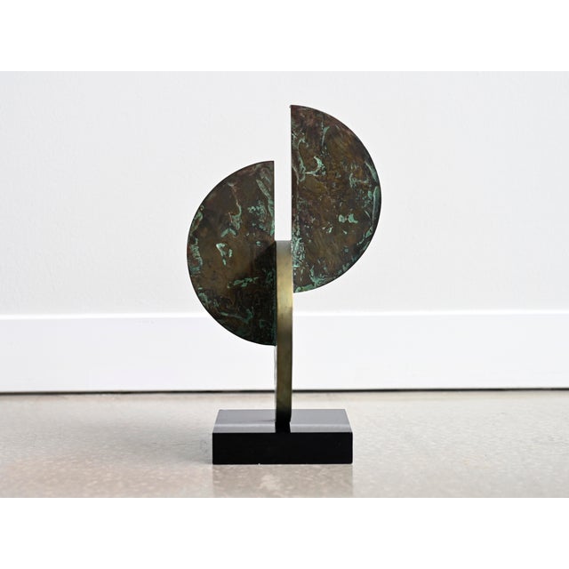 Vintage table top sculpture crafted in solid bronze affixed to a black lucite base. Body of sculpture features three...