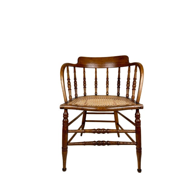A beautifully crafted Victorian or early 20th century barrel back armchair that moves between worlds effortlessly —...