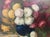 A richly painted floral still life depicting a generous arrangement of chrysanthemums and garden flowers gathered in a...