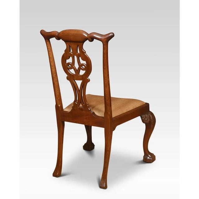 Pair of mahogany side chairs, each with a yoked crest rail above a pierced splat with quatrefoil cut-outs over a drop-in...