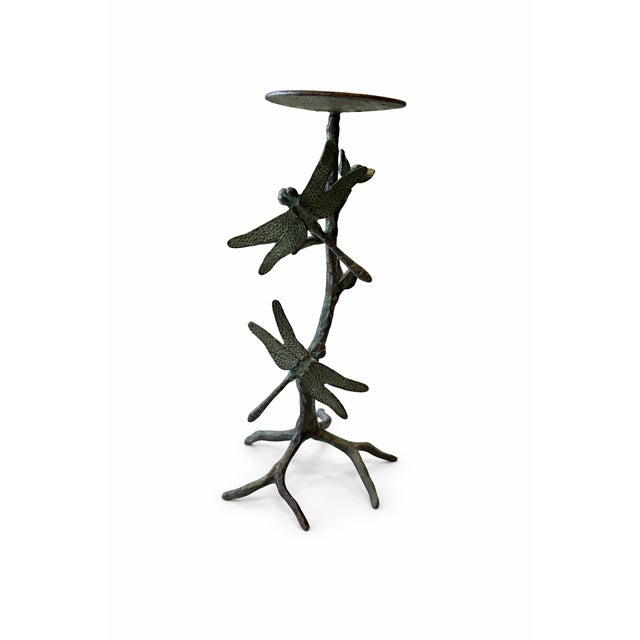 A sculptural vintage metal pillar candle holder featuring multiple dragonflies perched along an organically formed tree...