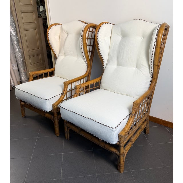 Pair of bamboo armchairs complete with polyurethane cushions and synthetic padding, the covering in pure heavy linen with...