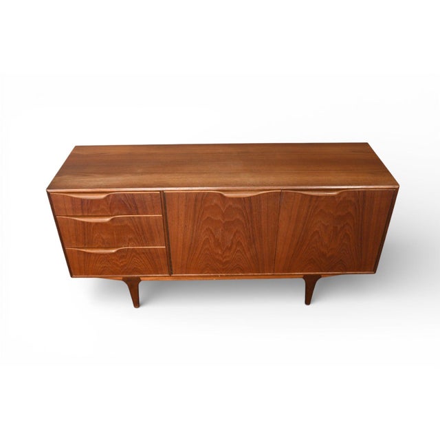 Origin: Scotland Designer: Val Rossi Manufacturer: A.H. McIntosh Era: 1960s Materials: Teak Measurements: 60" wide x 18"...
