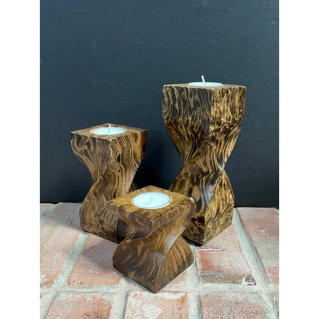 Trio of wood candleholders with a twisted design & marbled pattern resembling tortoise shell. We don’t know anything about...