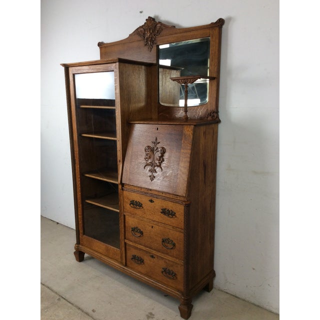 This antique oak side by side features three dovetailed drawers with brass hardware, compact drop front writing surface,...