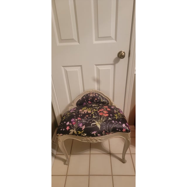 Vintage French Louis XV style black floral ornate seat. It has a light-colored potentially distressed or white-washed...