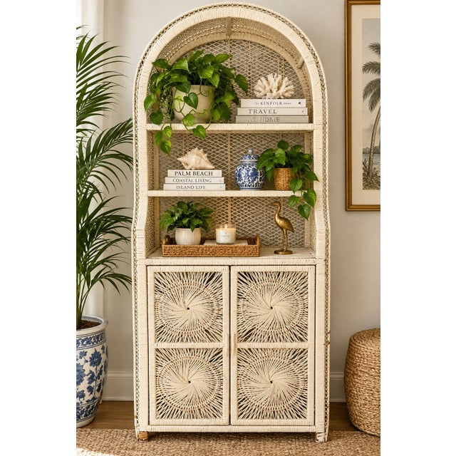 Beautiful vintage wicker and rattan hutch featuring an incredible tall arched silhouette, intricate woven latticework, and...