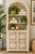 Beautiful vintage wicker and rattan hutch featuring an incredible tall arched silhouette, intricate woven latticework, and...