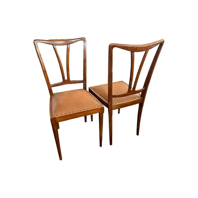 These modern Italian chairs are very light, yet sturdy. The seat features a nailhead design around the perimeter.